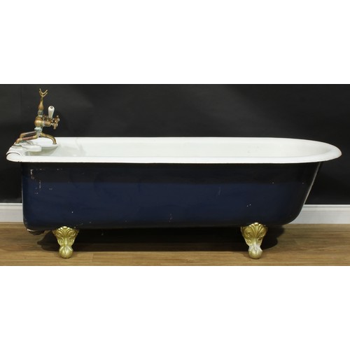 119 - An early to mid-20th century cast iron roll top bath, ball and claw feet, 58cm high excluding taps, ... 