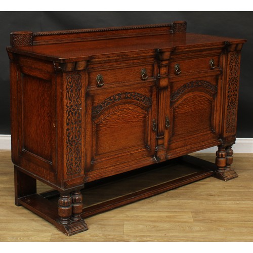 214 - An early 20th century oak side cabinet, carved with blind fretwork in the 17th century taste, 105.5c... 