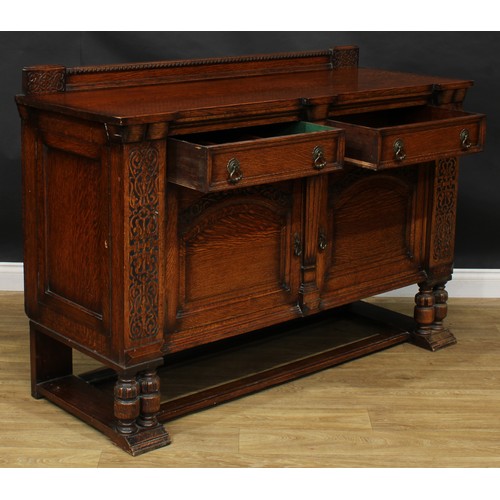 214 - An early 20th century oak side cabinet, carved with blind fretwork in the 17th century taste, 105.5c... 