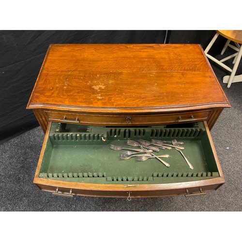 79 - An early 20th century oak Arts and Crafts style canteen side table, serpentine front, pair of shallo... 