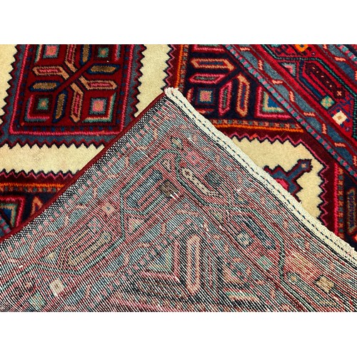 81 - A North West Persian Hamadan runner carpet, hand-knotted in tones of red, blue, turquoise and cream,... 