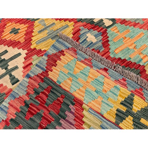 116 - A Turkish Anatolian Kilim, with geometrical design in bright tones of red, blue, turquoise, green, a... 