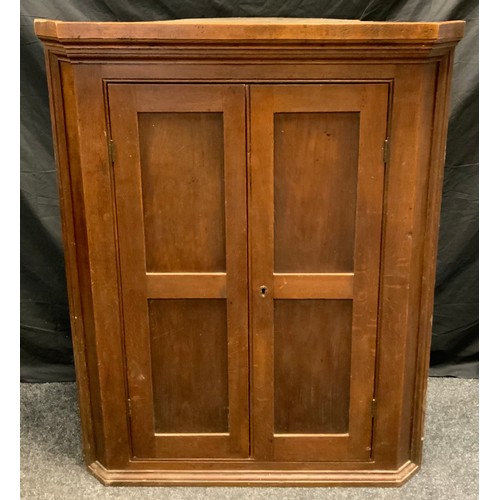 316 - A George III oak corner cupboard, panelled doors enclosing two tiers of shelving, 119cm high x 94.5c... 