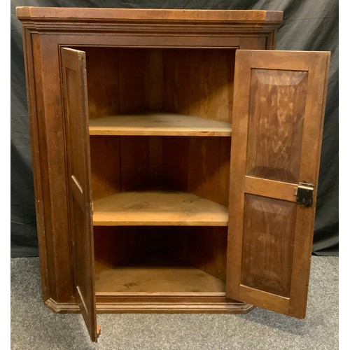 316 - A George III oak corner cupboard, panelled doors enclosing two tiers of shelving, 119cm high x 94.5c... 