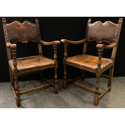 321 - A set of eight early 20th century oak dining chairs, tan leather upholstered backs and seats, turned... 