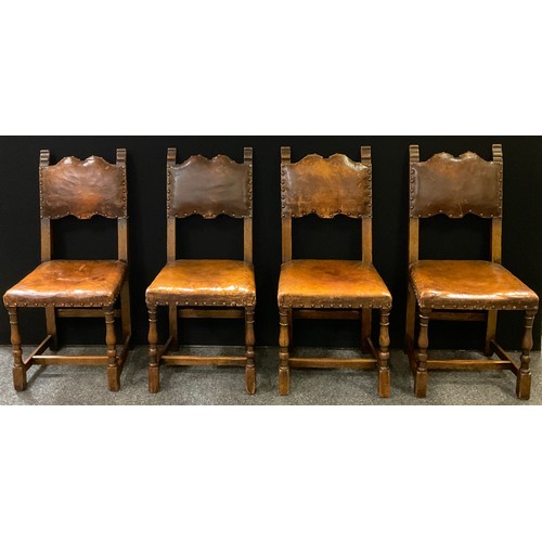 321 - A set of eight early 20th century oak dining chairs, tan leather upholstered backs and seats, turned... 