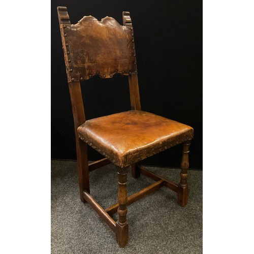 321 - A set of eight early 20th century oak dining chairs, tan leather upholstered backs and seats, turned... 