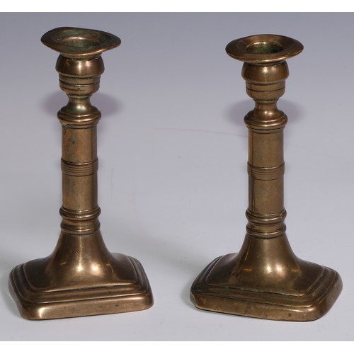 3653 - The Duke of Wellington and the Napoleonic Wars - a pair of George III brass candlesticks, campana sc... 