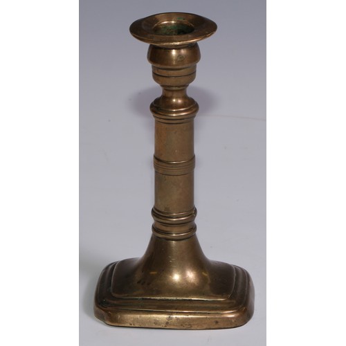 3653 - The Duke of Wellington and the Napoleonic Wars - a pair of George III brass candlesticks, campana sc... 