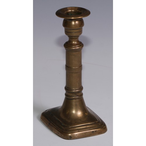 3653 - The Duke of Wellington and the Napoleonic Wars - a pair of George III brass candlesticks, campana sc... 