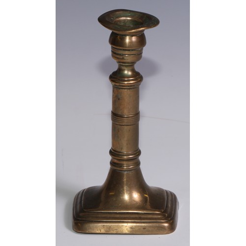 3653 - The Duke of Wellington and the Napoleonic Wars - a pair of George III brass candlesticks, campana sc... 