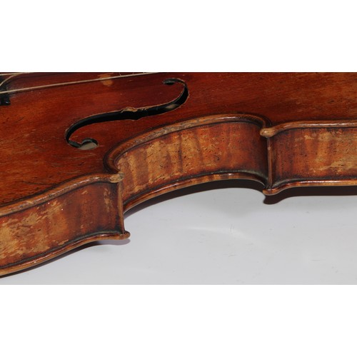 3062 - A 19th century violin, the well figured one-piece back 36cm long excluding button, outlined througho... 