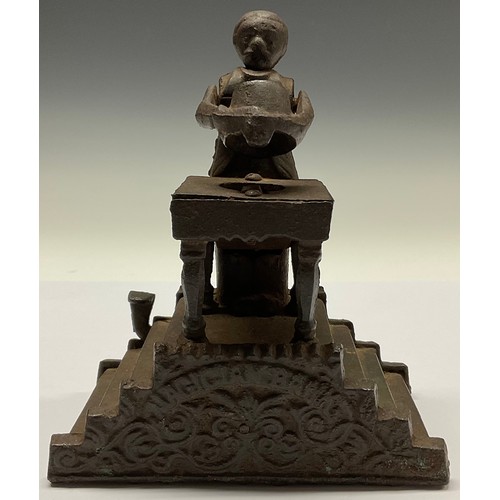 3073 - A cast iron novelty money box, the Magician bank, 19cm high