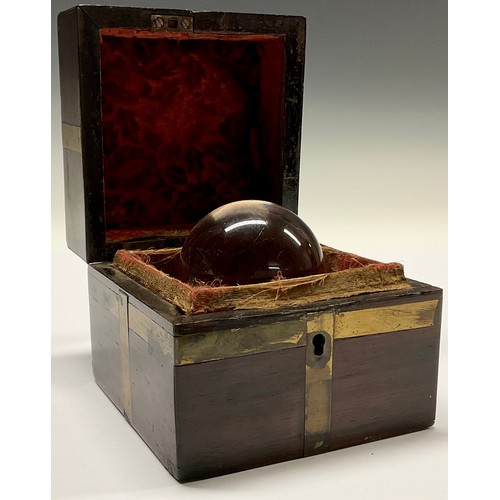 3629 - Mysticism and the Occult - a crystal ball, associated brass bound mahogany box, 10cm wide overall