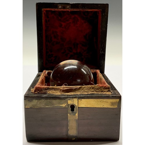 3629 - Mysticism and the Occult - a crystal ball, associated brass bound mahogany box, 10cm wide overall