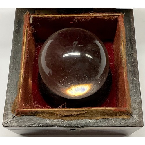 3629 - Mysticism and the Occult - a crystal ball, associated brass bound mahogany box, 10cm wide overall