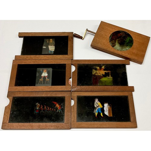 3661 - The Magic Lantern - an early 20th century mahogany rack-and-pinion mechanical automaton slide, depic... 