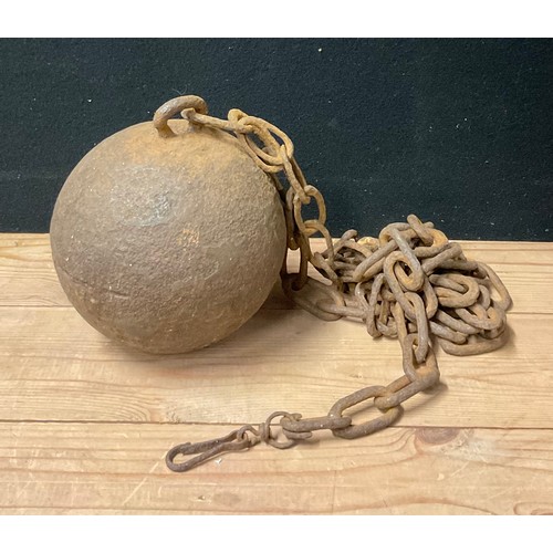 3631 - Penal History - a 19th century cast iron ball and chain, 24cm diam