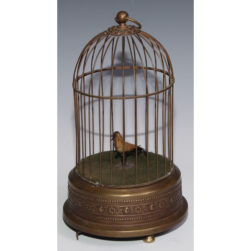 3065 - A brass clockwork novelty automaton, as a singing bird in a cage, suspension loop, 29cm high, 20th c... 