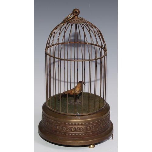 3065 - A brass clockwork novelty automaton, as a singing bird in a cage, suspension loop, 29cm high, 20th c... 