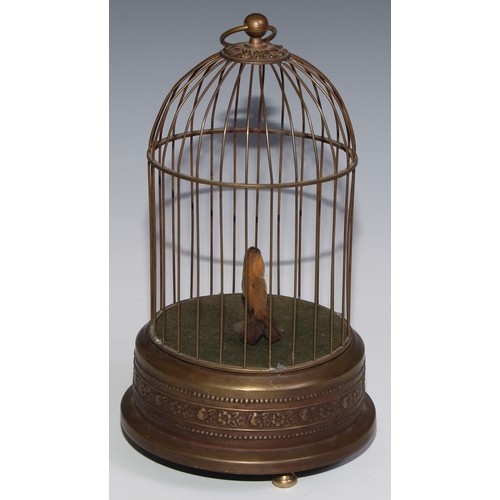 3065 - A brass clockwork novelty automaton, as a singing bird in a cage, suspension loop, 29cm high, 20th c... 