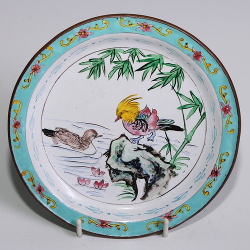 3070 - A Cantonese enamel shaped circular plate, painted in the famille rose palette with flowering branche... 