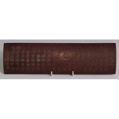 3076 - A Chinese bamboo scholar's calligraphy wrist rest, carved in relief with verse, 28cm long