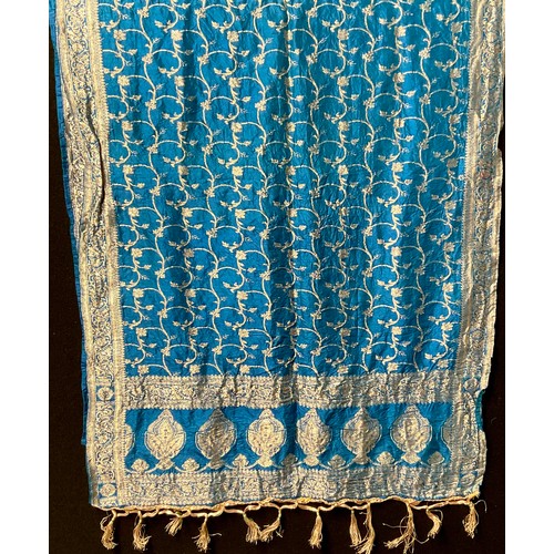 3648 - Textiles - an Indian katan silk shawl, worked in silvered thread with scrolling leafy stems on a blu... 