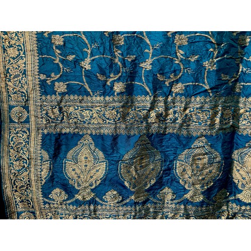 3648 - Textiles - an Indian katan silk shawl, worked in silvered thread with scrolling leafy stems on a blu... 