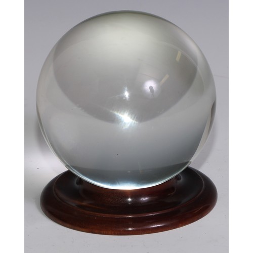 3628 - Mysticism and The Occult - a crystal ball, 11cm diam, turned mahogany stand