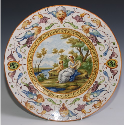 3088 - A 19th century tin glazed earthenware charger, painted in polychrome in the Istoriato taste, 40.5cm ... 