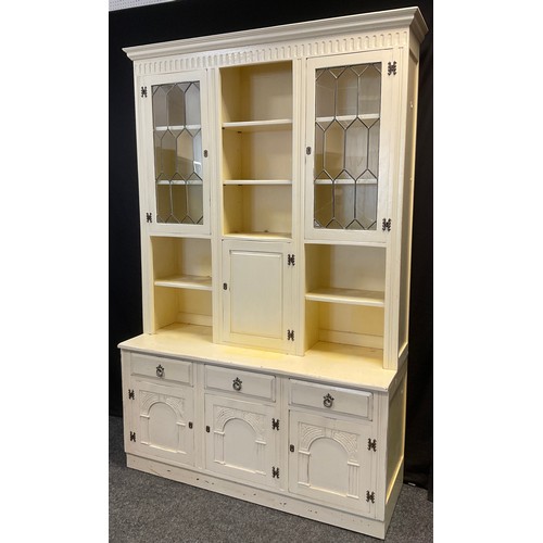 103 - An early 20th century white painted oak kitchen dresser, having an arrangement of cupboards and shel... 