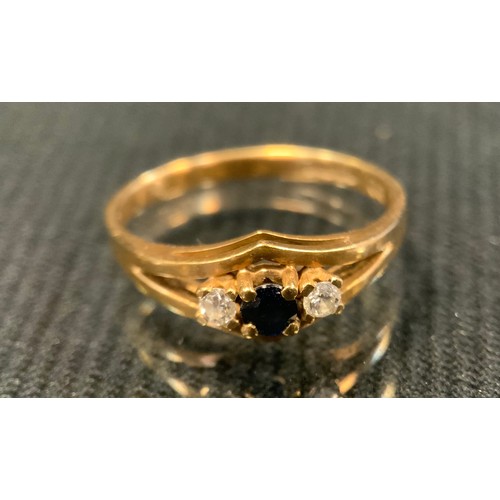 423 - A sapphire and diamond three stone line ring, size M, 9ct gold shank, 1.9g gross;  9ct gold wedding ... 