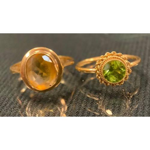 425 - A 9ct gold peridot dress ring;  others garnet etc, part unmarked, sizes P-L, 9g gross (5)