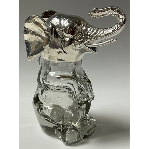 49 - A contemporary silver plated and glass novelty jar and cover, in the form of an elephant, glass eyes... 