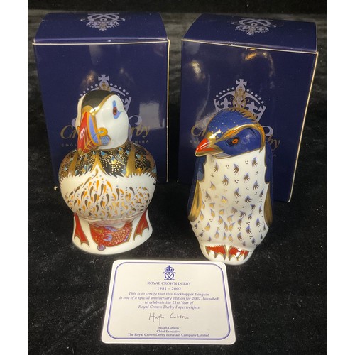 57 - A Royal Crown Derby paperweight, Rockhopper Penguin, 21st anniversary gold stopper, certificate, box... 