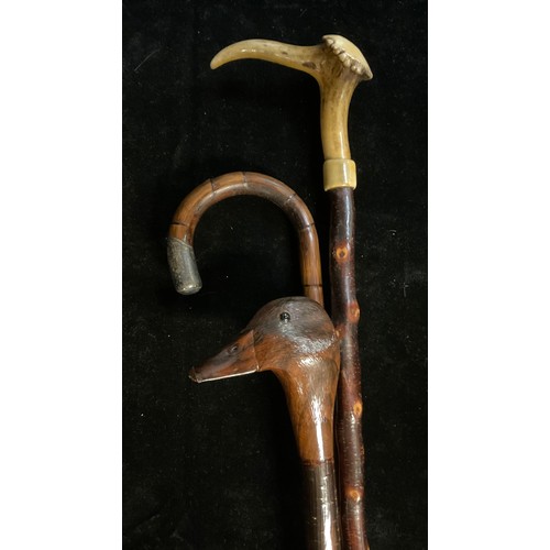126 - Walking Sticks - a silver mounted bamboo walking stick, London 1914; another, the handle carved as a... 