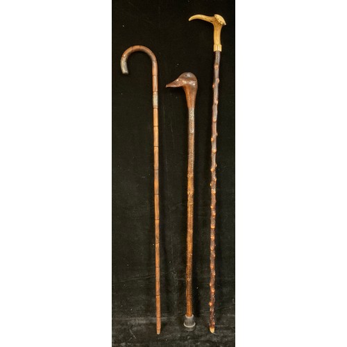 126 - Walking Sticks - a silver mounted bamboo walking stick, London 1914; another, the handle carved as a... 