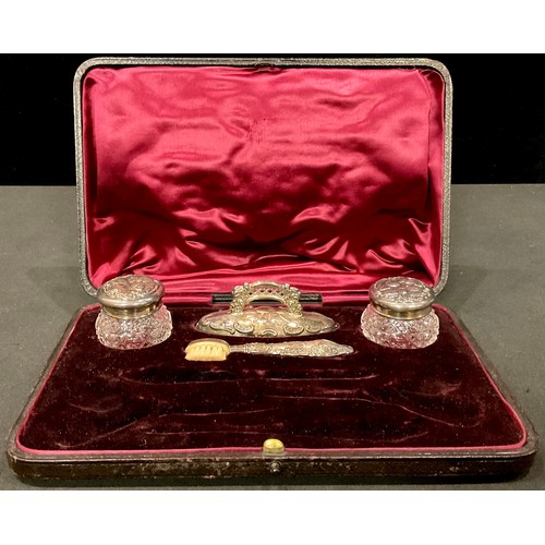 154 - A part silver manicure set; two cherub topped jars; a buffer and brushes