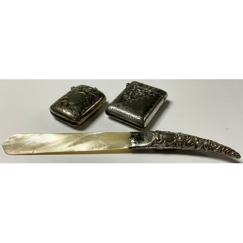158 - An Edwardian silver vesta case, Chester 1903, 30g; a Victorian silver and mother-of-pearl paper knif... 