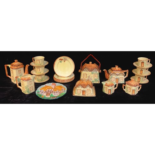 172 - A Staffordshire English thatched cottage teapot, six cups, saucers and plates, biscuit barrel, butte... 