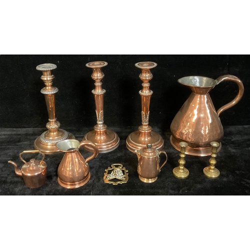 518 - A 19th century copper flagon, 23cm; a pair of copper candlesticks gadrooned spreading circular sconc... 