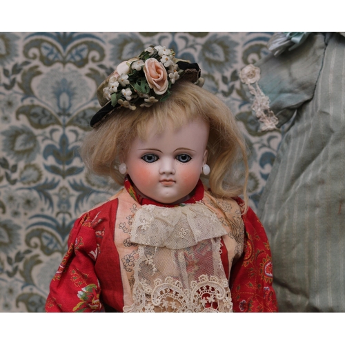 2130 - A 19th century pale bisque shoulder head French Poupée de Mode or fashion doll, the bisque head inse... 