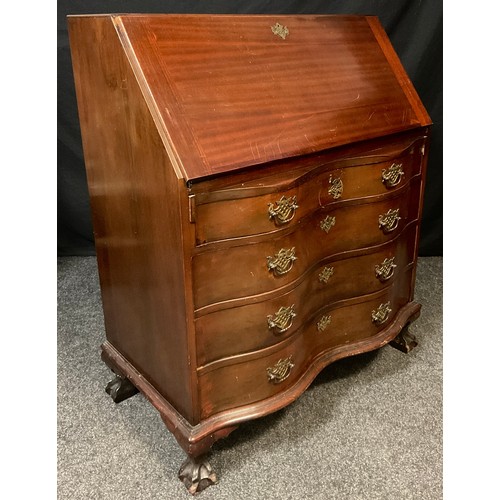 35 - A mid 20th century serpentine front mahogany bureau, fall front enclosing fitted interior, above fou... 