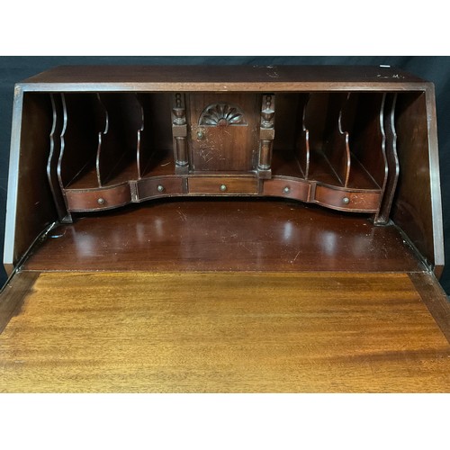 35 - A mid 20th century serpentine front mahogany bureau, fall front enclosing fitted interior, above fou... 