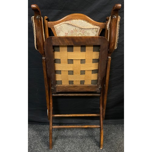 69 - A late Victorian mahogany folding campaign chair, shield-shaped back, upholstered back, arms, and se... 