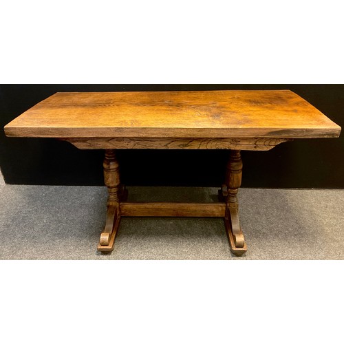 82 - A 20th century Arts and crafts style oak trestle table, solid quarter-sawn oak top, turned supports,... 