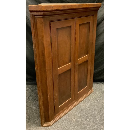 93 - A George III oak corner cupboard, panelled doors enclosing two tiers of shelving, 119cm high x 94.5c... 