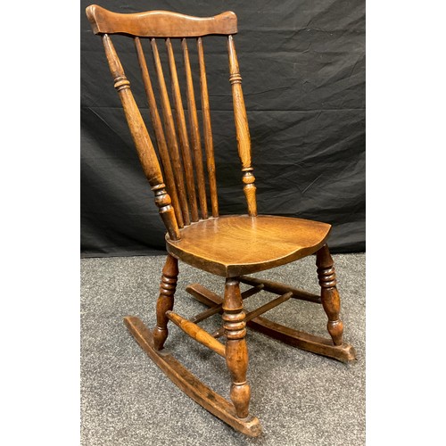 111 - A 19th century Elm spindle-back rocking chair, 91cm high x 44.5cm wide;  an elm lathe back chair, c.... 