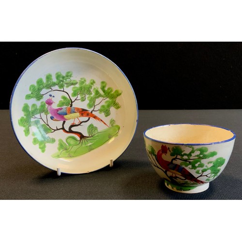 162 - An 18th/19th century soft paste porcelain tea bowl and saucer, decorated in the Chinese taste with a... 